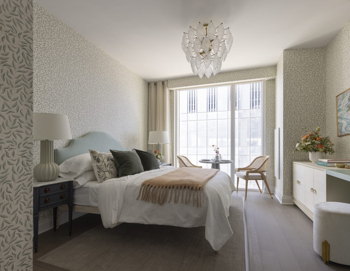 A contemporary bedroom with a chandelier, neutral color scheme, and modern furnishings.