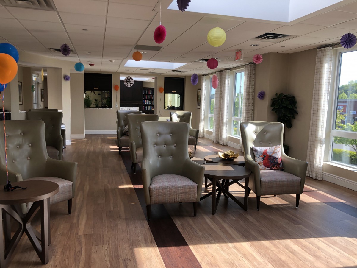 A well-lit lounge area with comfortable seating and colorful decorations.