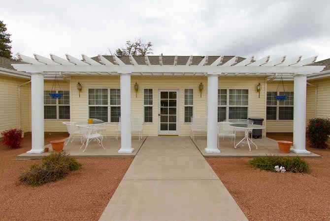 A single-story building with a front patio and white columns.