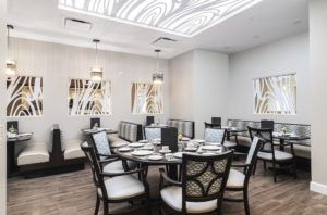 A modern and elegantly designed restaurant dining room with well-arranged tables and chairs.