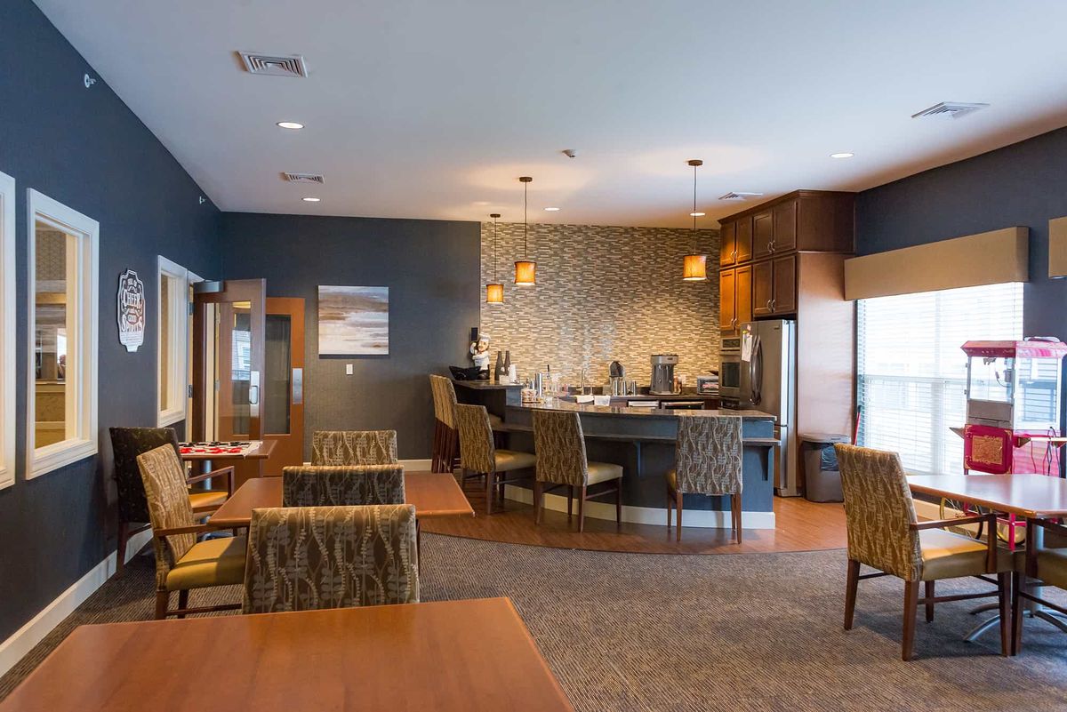 A modern restaurant interior with a bar and seating area.