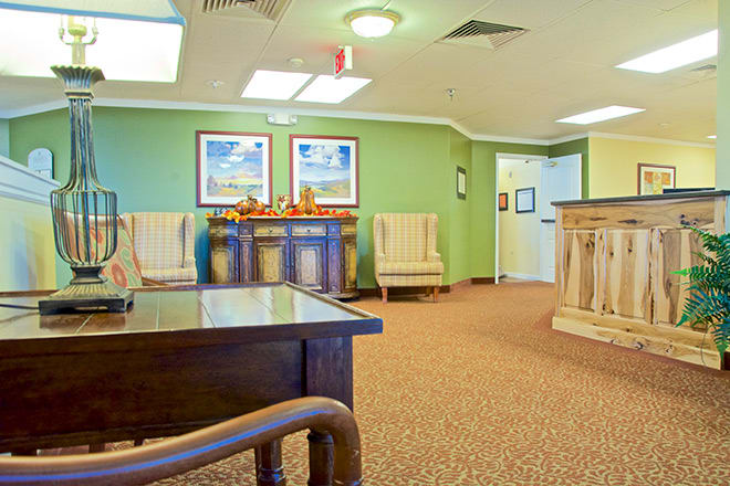 A cozy waiting room with comfortable seating and decorative artwork.