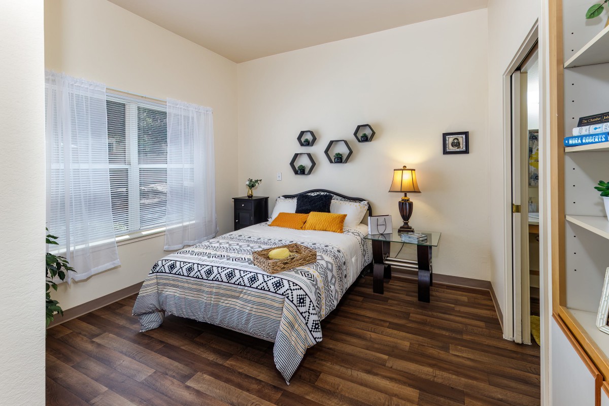 A modern bedroom with stylish decor, including a bed, bedside tables, and wall art.