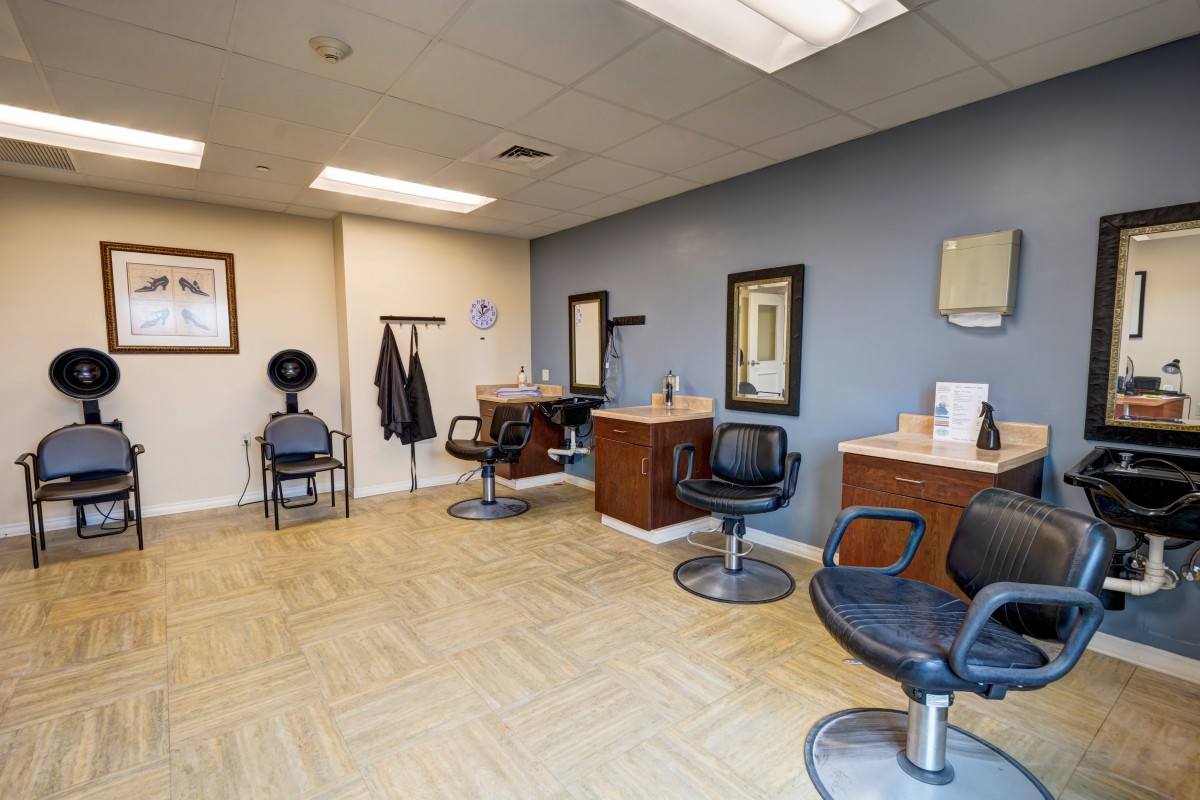A well-lit hair salon interior featuring styling chairs, mirrors, and essential equipment.