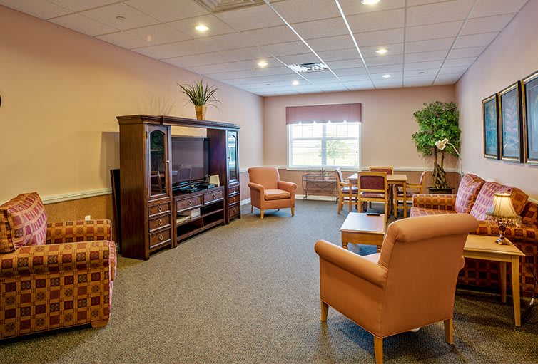A cozy living room with comfortable seating and a large TV unit.