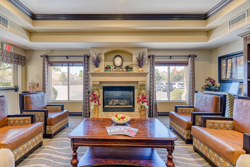 A well-decorated living room with a central fireplace and comfortable seating.