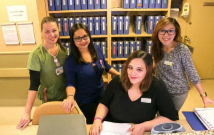 A group of women working together in an office setting.