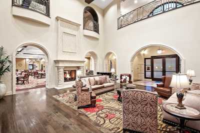 Spacious and luxurious living room with elegant decor and a cozy fireplace.
