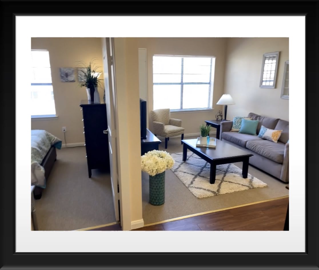 A modern apartment showcasing a cozy living room and adjoining bedroom.