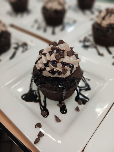 Decadent chocolate cupcake topped with creamy frosting and chocolate chips.