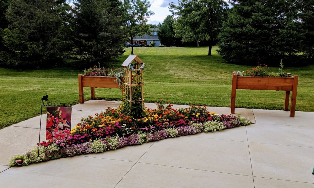 A well-maintained garden with colorful flowers and raised planters in a peaceful outdoor setting.