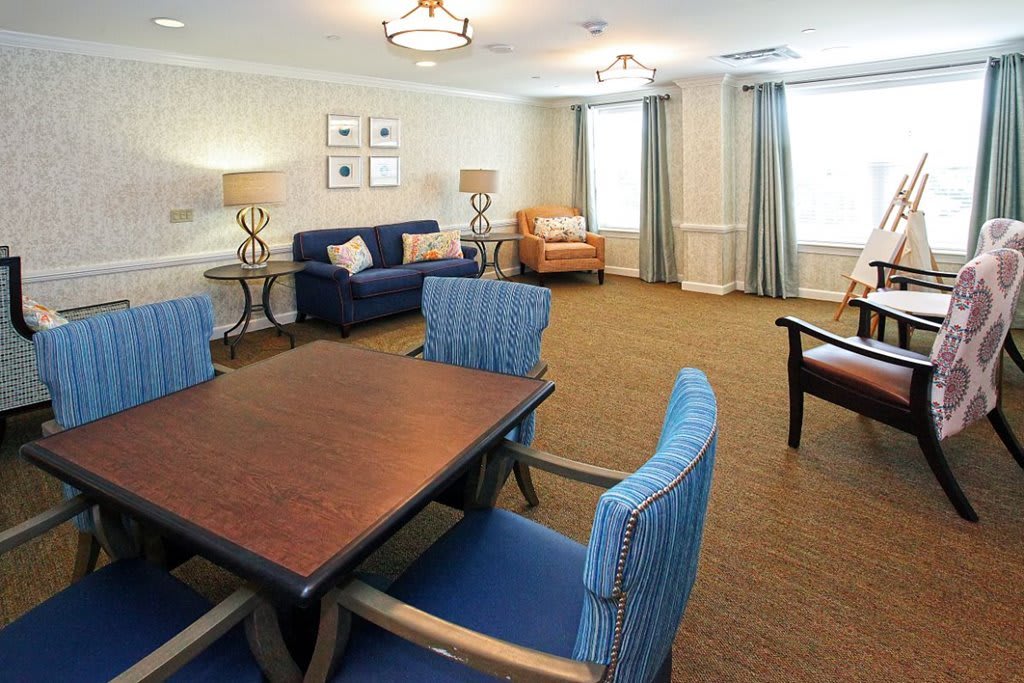 A cozy living room with a seating area and elegant decor.