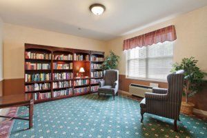 A cozy library corner with bookshelves and armchairs.