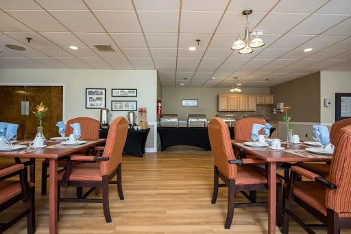 A cozy and modern dining area with neatly arranged tables, chairs, and tasteful decor.