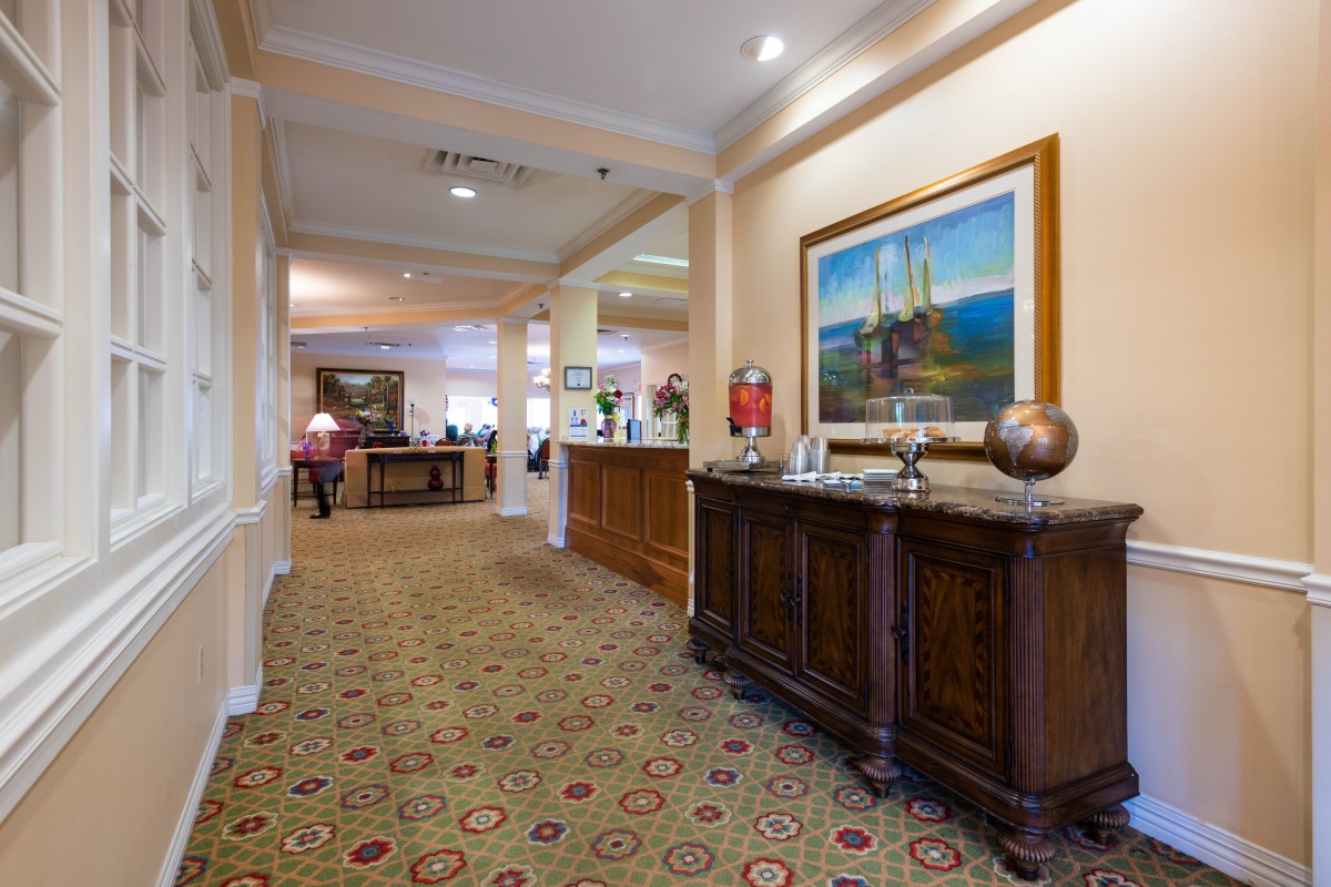 A well-decorated lobby area with furniture and a painting on the wall.
