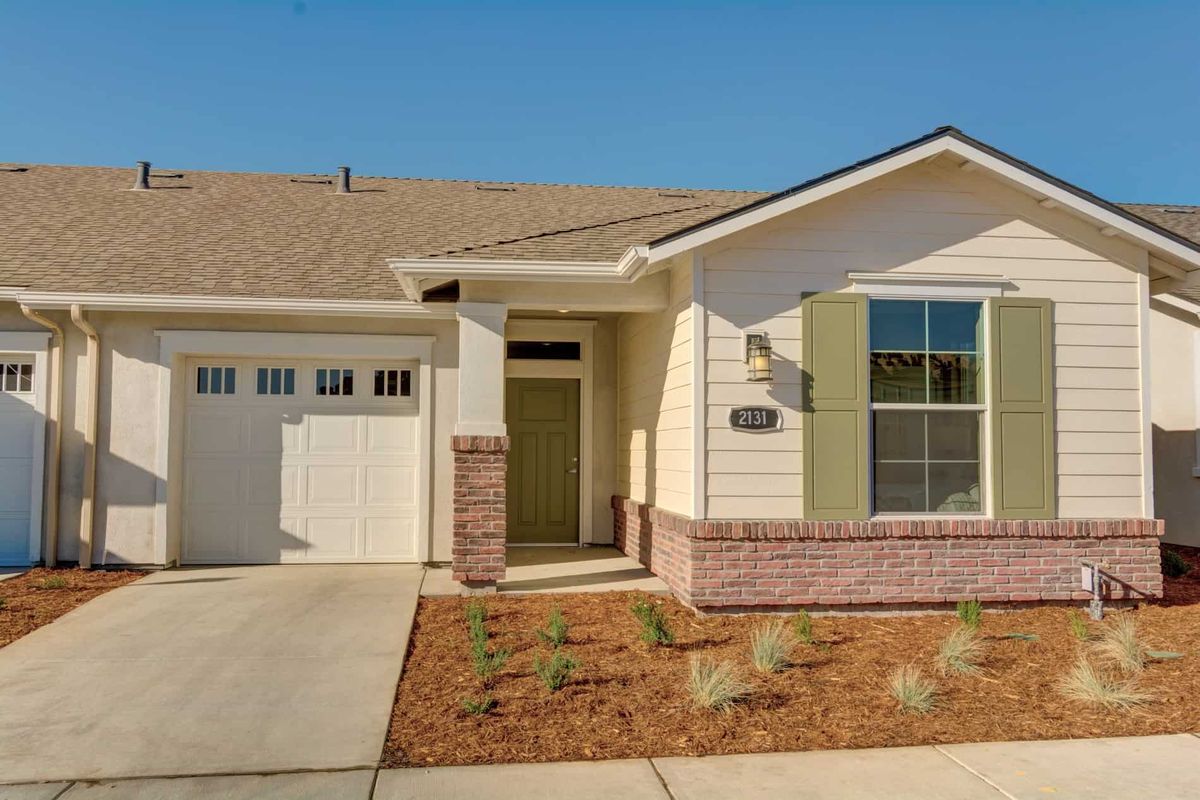 A single-story house with a garage and brick facade.