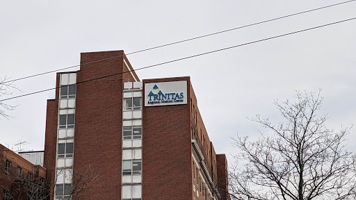 A view of a brick building featuring signage for a business.