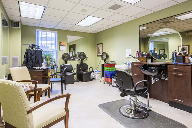 Interior view of a hair salon with chairs and salon equipment.