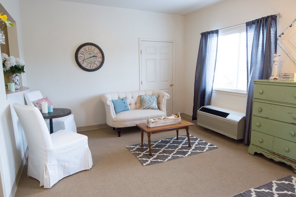 A cozy living room with a sofa, coffee table, and decorative elements.