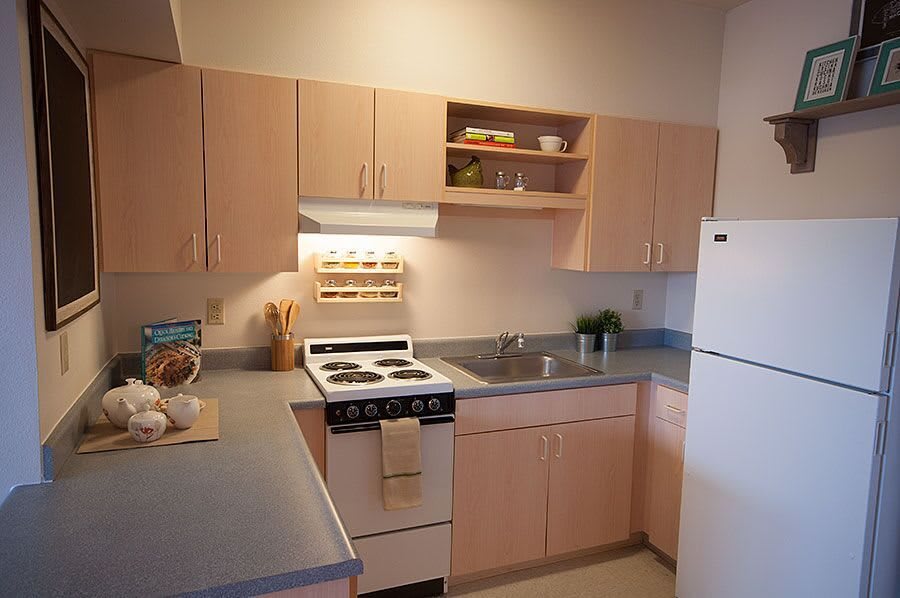 A clean and organized kitchen with modern appliances and wooden cabinets.