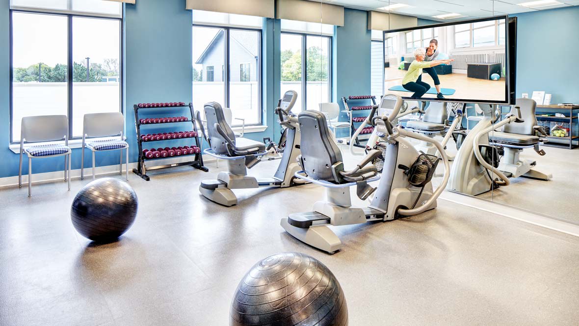 A well-equipped gym with various exercise machines and weights.