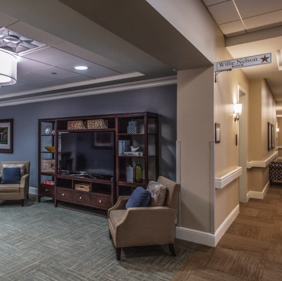 A cozy waiting area with comfortable seating and a bookshelf.