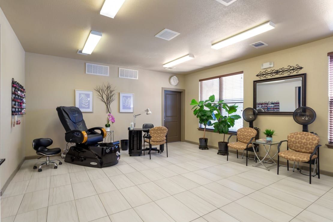 A modern nail salon interior with a pedicure chair and waiting area.