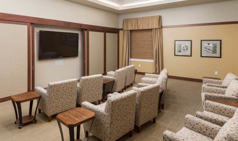 A conference room with arranged seating and a television for presentations.