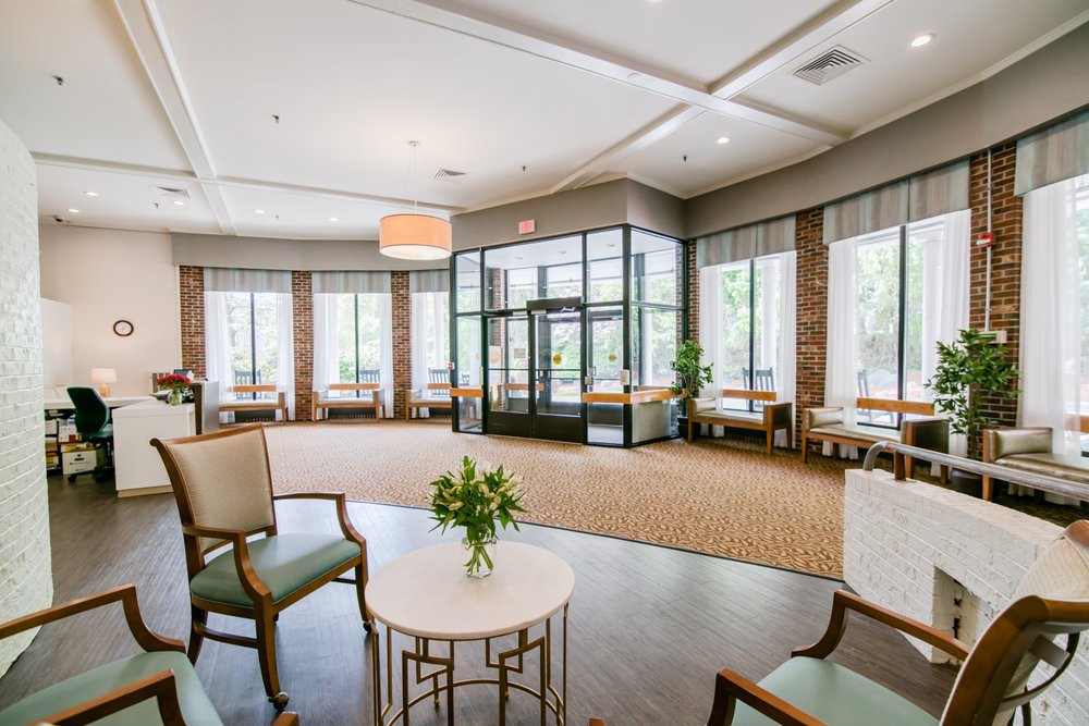A modern lobby area with comfortable seating and large windows.