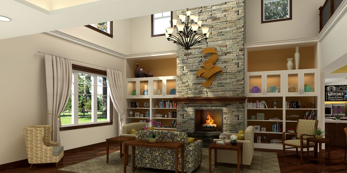A cozy living room with a stone fireplace, elegant chandelier, and built-in bookshelves.