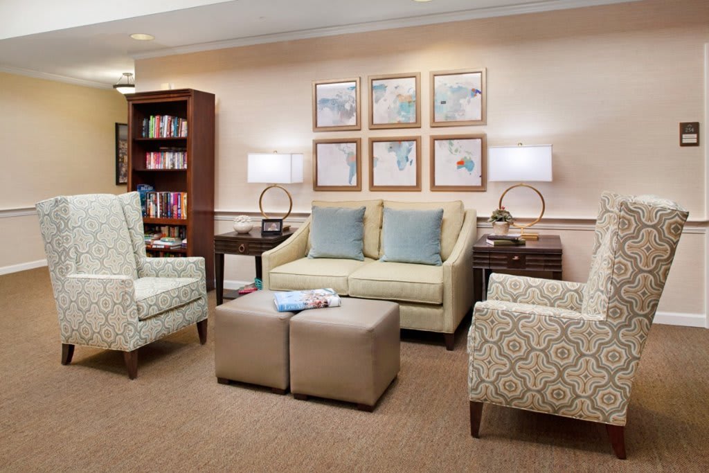 A cozy living room with comfortable seating and a bookshelf.