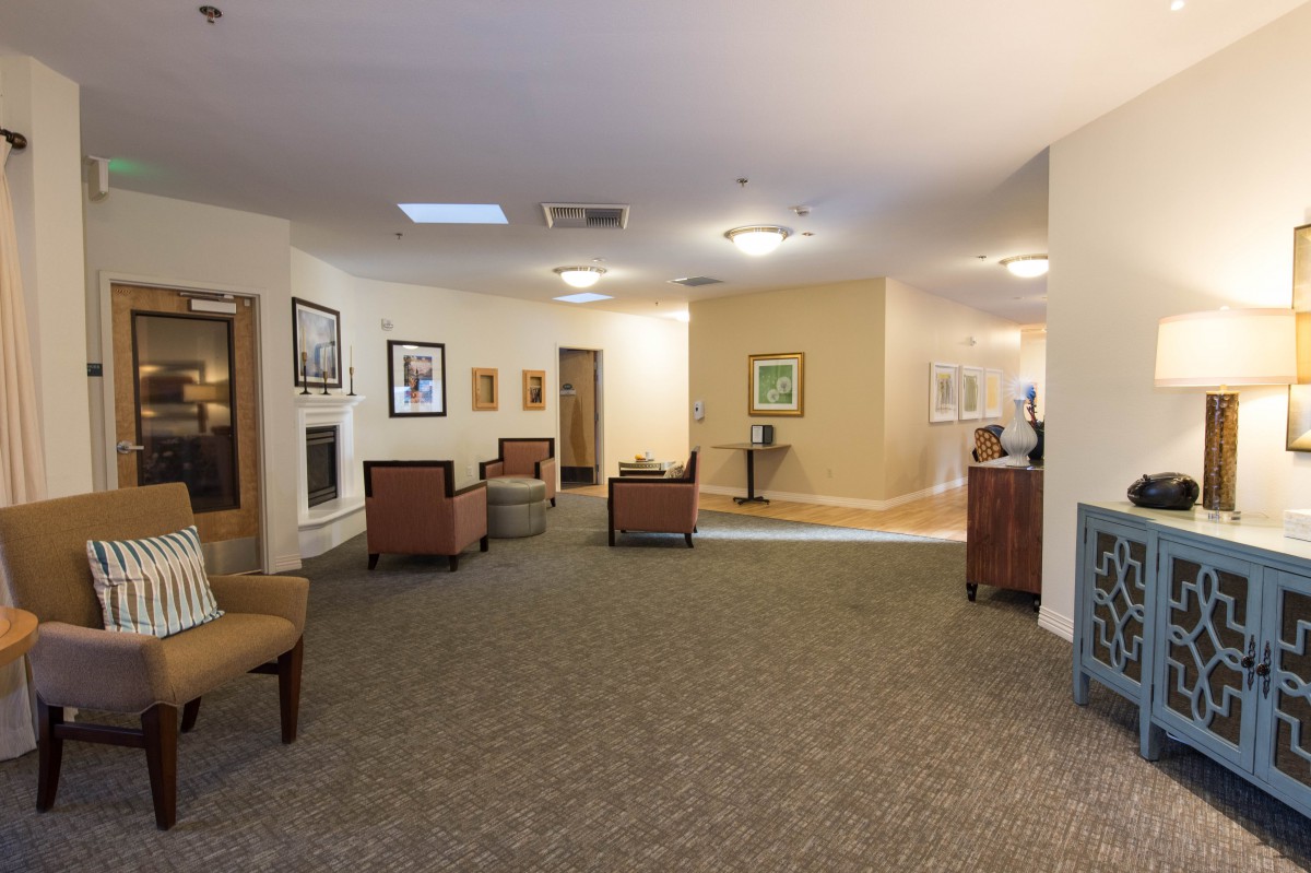 A spacious lobby with comfortable seating and artwork on the walls.