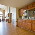 A spacious kitchen with wooden cabinets and modern appliances.