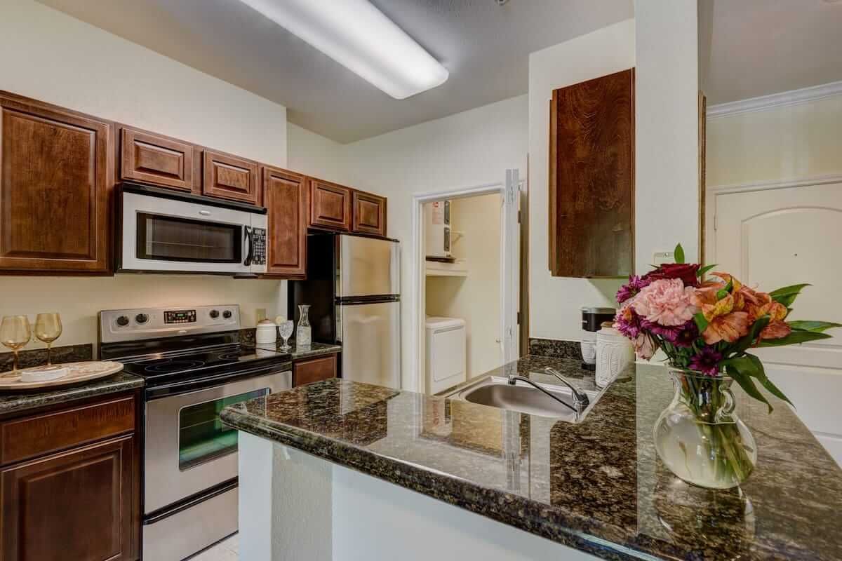 A modern kitchen featuring stainless steel appliances and granite countertops.