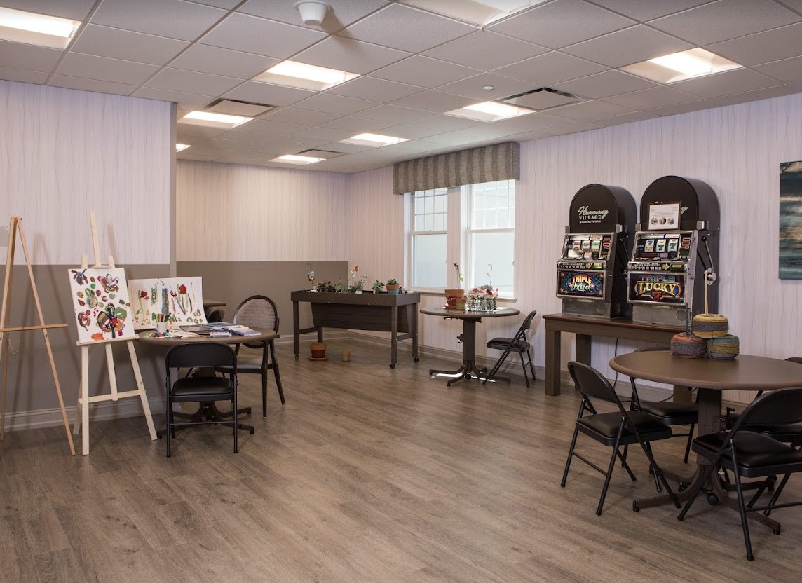 A versatile room featuring tables, chairs, a foosball table, and magazine racks.