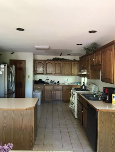A spacious kitchen featuring wooden cabinetry and modern appliances.