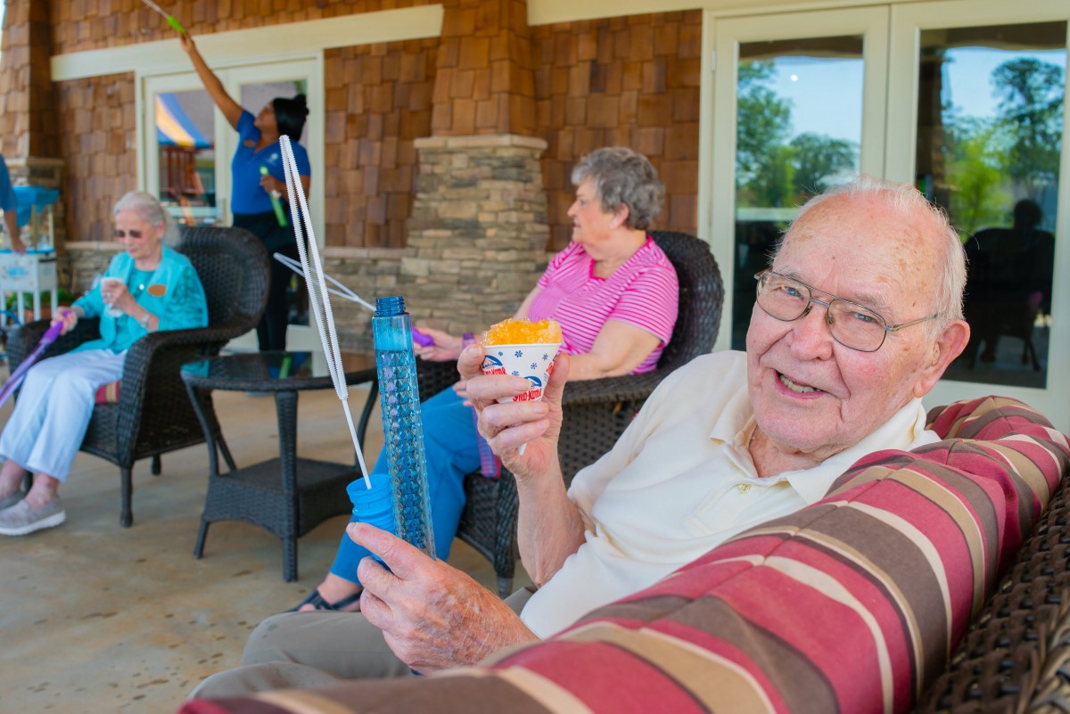 Seniors enjoying a relaxing gathering outdoors with refreshments.