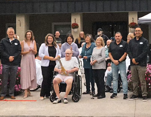 A joyful community gathering celebrating together outdoors.