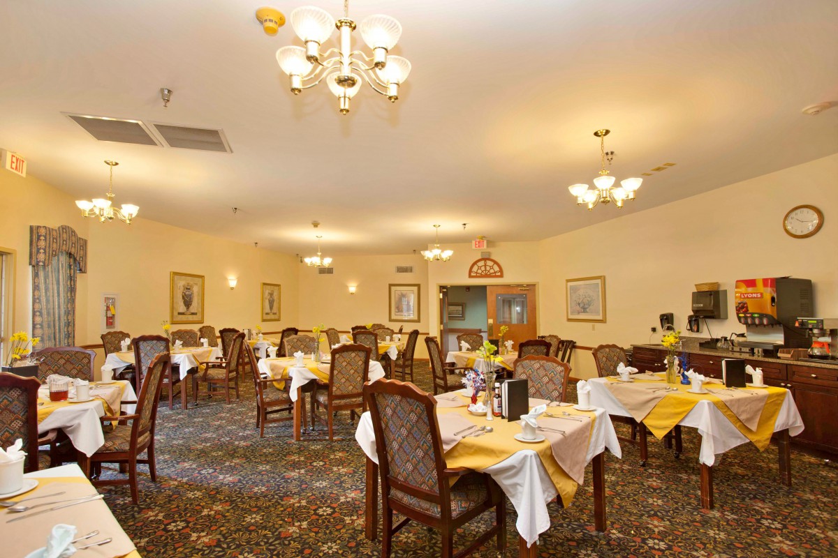 A cozy restaurant dining area with well-arranged tables and elegant chandeliers.