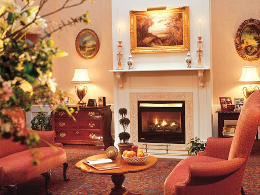 A cozy living room featuring a warm fireplace and elegant decor.