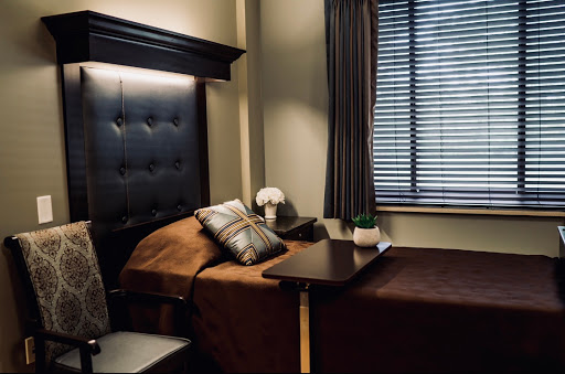 A serene and cozy bedroom setting featuring a neatly made bed, stylish decor, and soft lighting.