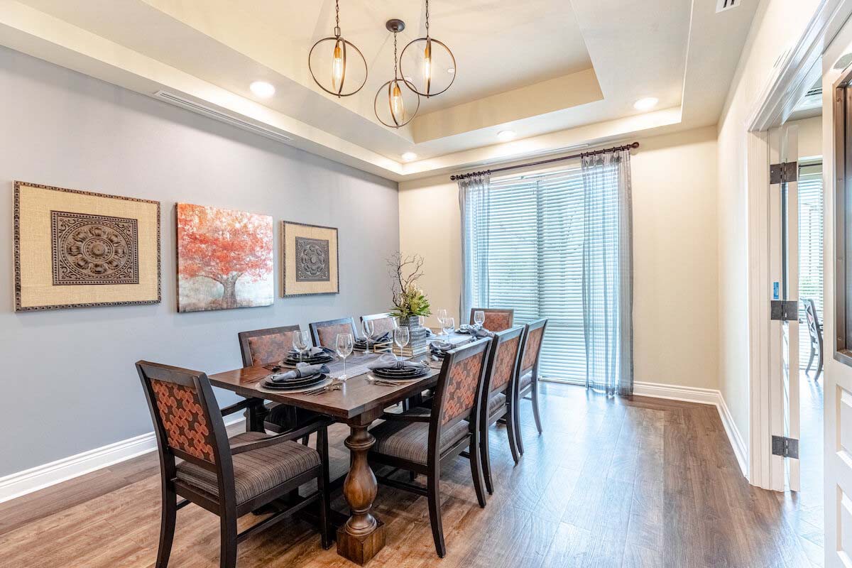 A well-furnished dining room with elegant decor and a stylish chandelier.