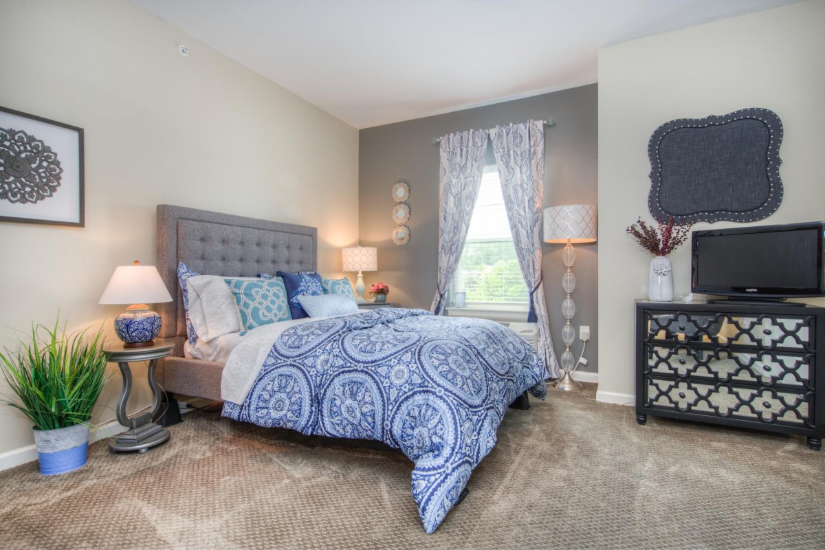 A cozy and elegant bedroom with stylish decor and comfortable bedding.