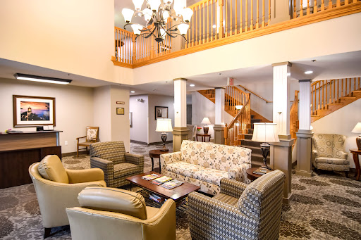 A cozy lobby area featuring comfortable seating and warm lighting.