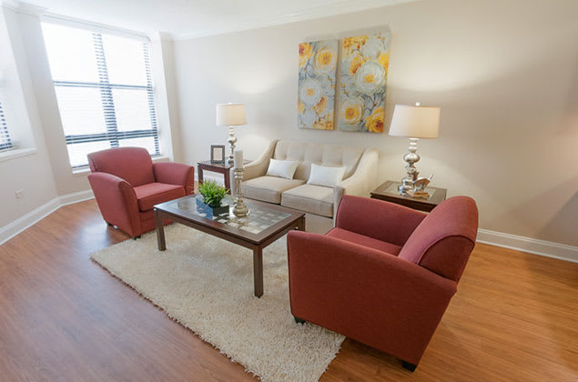 A cozy living room with stylish furnishings and colorful artwork.