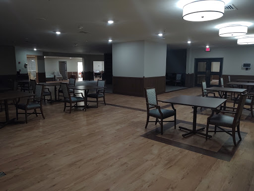 A spacious dining area featuring contemporary furniture and ample lighting.