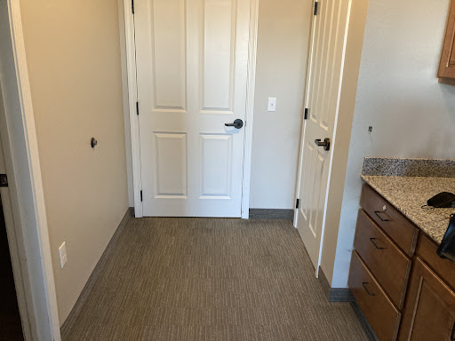 A view of a small room featuring two doors and light-colored walls.