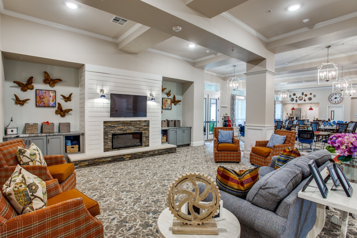 A modern living room with a fireplace, comfortable seating, and stylish decor.