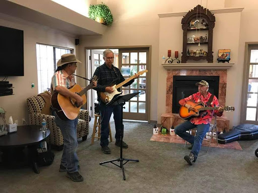 A lively performance by three musicians showcasing their talent in a cozy indoor setting.