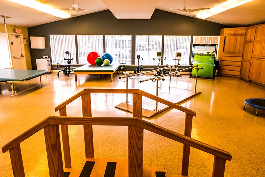 A rehabilitation center equipped with exercise equipment and therapy balls for physical therapy sessions.